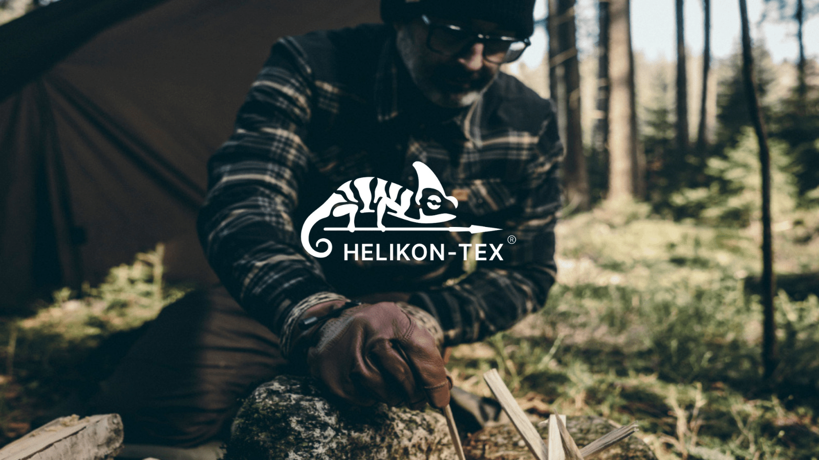 Tactical operator in a forest wearing tactical leather gloves and preparing fire